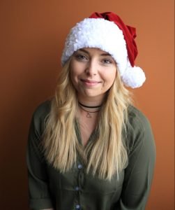 Girl smiling with Santa hat on