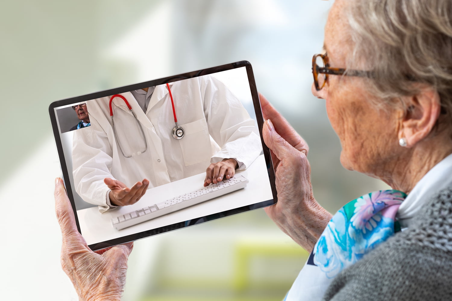 Elderly woman uses Telehealth to meet with doctor