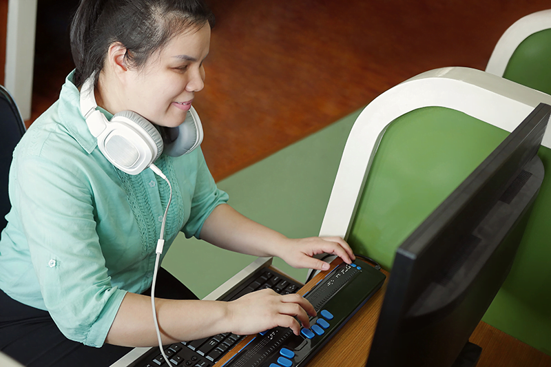 Visually impaired girl on computer